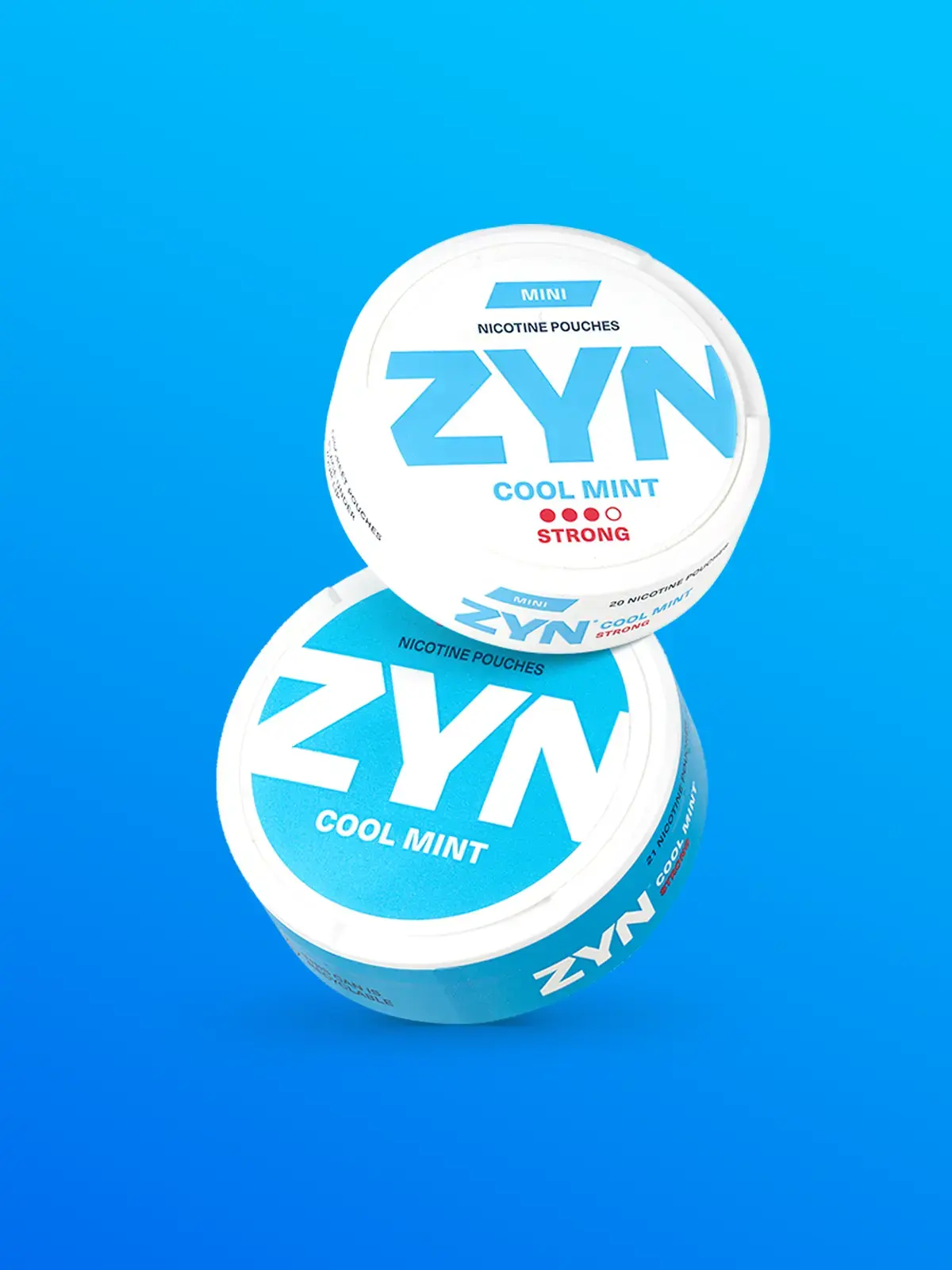 Two tins of Zyn nicotine pouches; Zyn Mini in Cool Mint flavour and Zyn regular in Cool Mint flavour in front of a blue background
